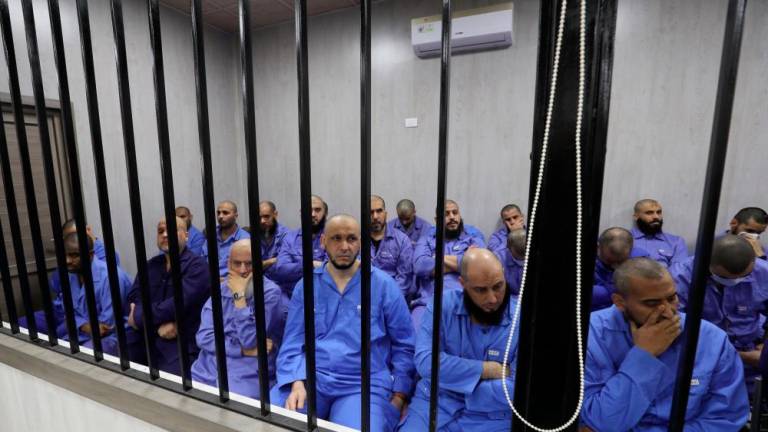 Jihadists accused of being members of the Islamic State (IS) group sit in the defendant booth during their trial, in the northwestern Libyan city of Misrata on May 29, 2023/AFPPix