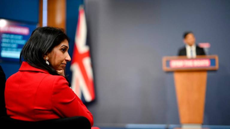 Britain’s Home Secretary Suella Braverman listens as Britain’s Prime Minister Rishi Sunak speaks during a press conference in the Downing Street Briefing Room in central London on March 7, 2023, following the announcement of the on the Illegal Migration Bill. AFPPIX