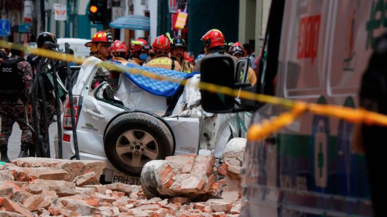 View of a destroyed car after the cornice and terrace of a building located in Cuenca's historic center fell, leaving one dead and one person injured, after an earthquake in Cuenca, Ecuador on March 18, 2023. AFPPIX