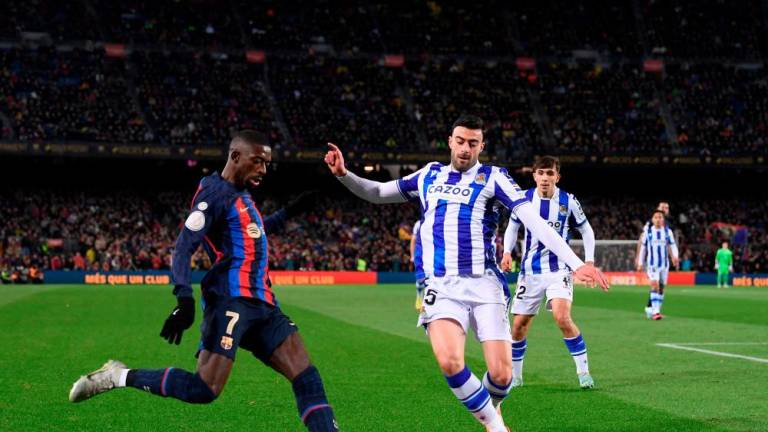 Barcelona's French forward Ousmane Dembele (L) vies with Real Sociedad's Spanish midfielder Igor Zubeldia during the Spain's Copa del Rey (King's Cup), quarter final football match between FC Barcelona and Real Sociedad, at the Camp Nou stadium in Barcelona on January 25, 2023/AFPPIX