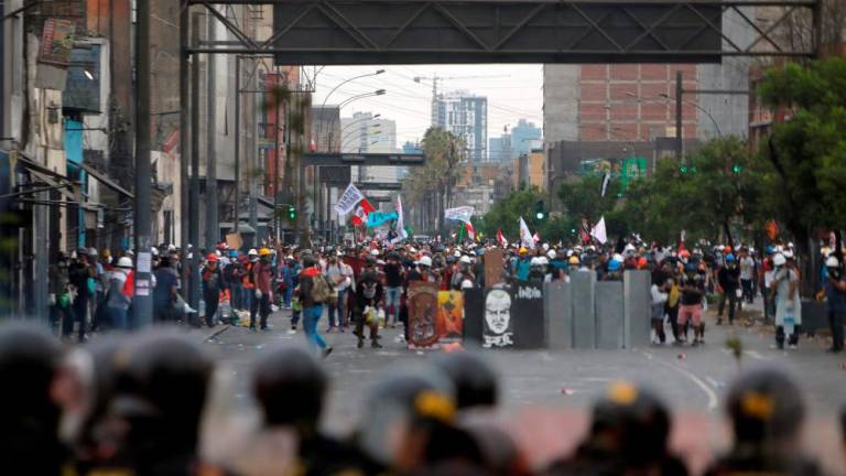 Demonstrators clash with riot police during a protest against the government of Peruvian President Dina Boluarte in Lima on January 28, 2023/AFPPix