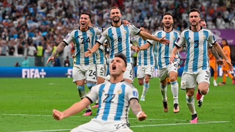 Argentina's forward #22 Lautaro Martinez celebrates after scoring his penalty and qualifying to the next round after defeating Netherlands in the penalty shoot-out of the Qatar 2022 World Cup quarter-final football match between Netherlands and Argentina at Lusail Stadium, north of Doha, on December 9, 2022/AFPix