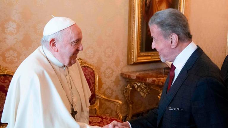 This photo taken and handout on Septembre 8, 2023 by The Vatican Media shows Pope Francis (L) meeting with US actor Sylvester Stallone during a private audience in The Vatican. AFPPIX