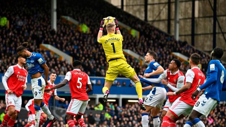 Arsenal’s English goalkeeper Aaron Ramsdale jumps to catch the ball during the English Premier League football match between Everton and Arsenal at Goodison Park in Liverpool, north-west England, on February 4, 2023/AFPPix