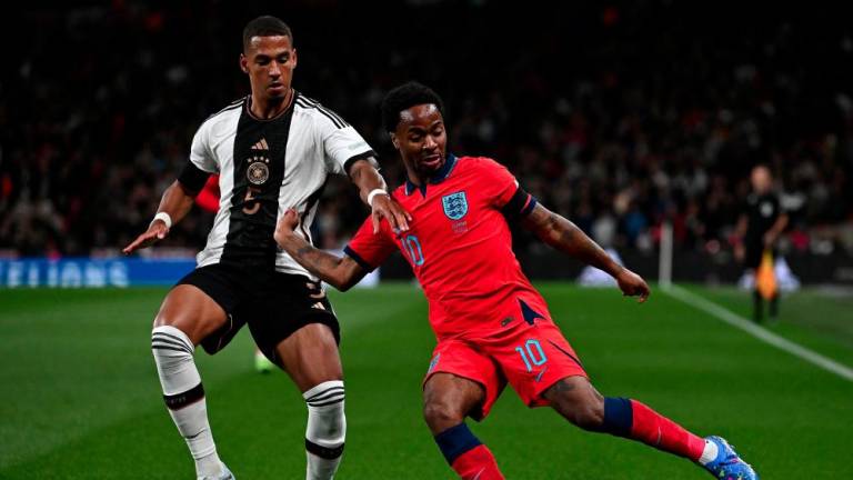 TOPSHOT - Germany's defender Thilo Kehrer (L) vies with England's midfielder Raheem Sterling during the UEFA Nations League group A3 football match between England and Germany at Wembley stadium in north London on September 26, 2022. - AFPPIX