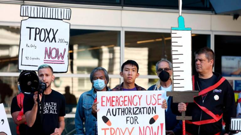 SAN FRANCISCO, CALIFORNIA - AUGUST 08: Healthcare and LGBTQ rights activists holds signs as they stage a protest outside of the San Francisco Federal Building on August 08, 2022 in San Francisco, California. AFPPIX