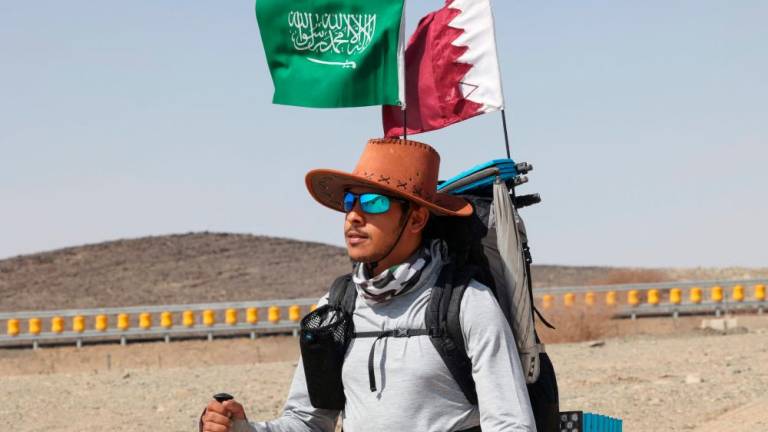 Saudi trekker Abdullah Alsulmi crosses a desert area near al-Khasrah area, some 350Km west of Riyadh, on Septembre 27, 2022, during his solo trek to the Qatari capital ahead of the FIFA World Cup. AFPPIX