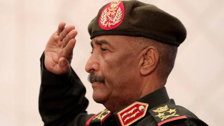 Sudan's Army chief Abdel Fattah al-Burhan salutes during the signature ceremony of an initial deal with civilian leaders aimed at ending a deep crisis caused by last year's military coup, in the capital Khartoum on December 5, 2022. - AFPPIX