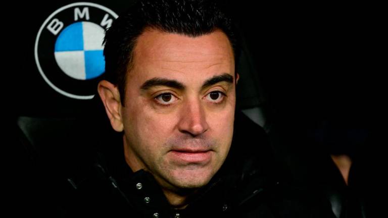 Barcelona’s Spanish coach Xavi looks on before the start of the Copa del Rey (King’s Cup) semi final first Leg football match between Real Madrid CF and FC Barcelona at the Santiago Bernabeu stadium in Madrid on March 2, 2023. AFPPIX