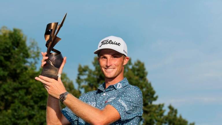 MEMPHIS, TENNESSEE - AUGUST 14: Will Zalatoris of the United States poses with the trophy after putting in to win on the third playoff hole on the 11th green during the final round of the FedEx St. Jude Championship at TPC Southwind on August 14, 2022 in Memphis, Tennessee. AFPPIX