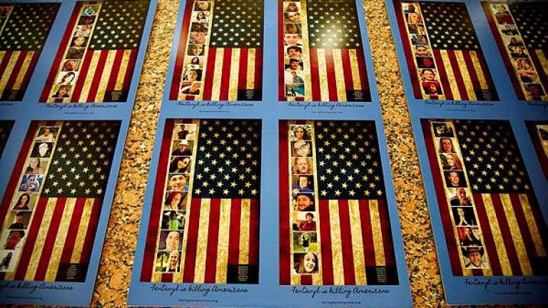 Photos of Americans who died from a fentanyl overdose are displayed at the Drug Enforcement Administration (DEA) headquarters in Arlington, Virginia, on July 13, 2022. - AFPPIX