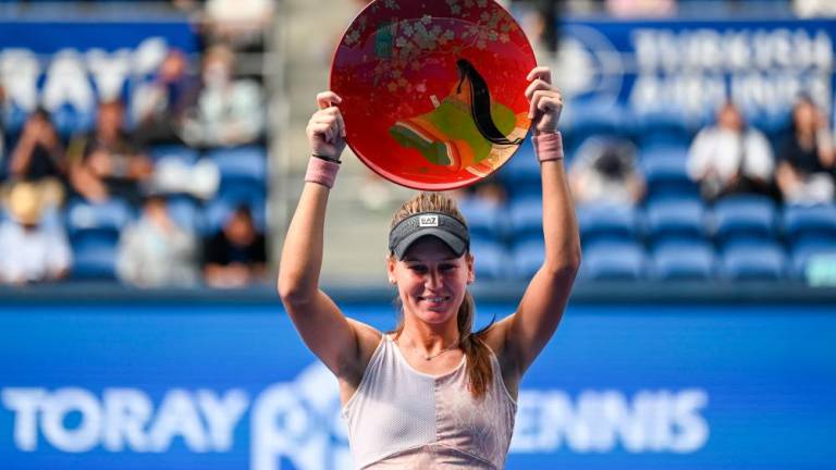 Veronika Kudermetova of Russia holds up the winner’s trophy at the awards ceremony following her victory over Jessica Pegula of the US in the women's singles final of the Pan Pacific Open tennis tournament in Tokyo on October 1, 2023. - AFPPIX