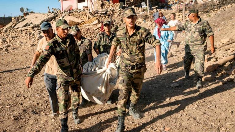 Moroccan Royal Armed Forces evacuate a body from a house destroyed in an earthquake in the mountain village of Tafeghaghte, southwest of the city of Marrakesh, on September 9, 2023. AFPPIX