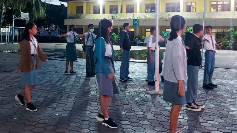 This picture taken on March 6, 2023 shows high school students gathering for the roll call on campus early in the morning in Kupang. A pilot project in Kupang, the capital of East Nusa Tenggara province, has twelfth-graders at 10 high schools starting classes at 5:30 am. AFPPIX