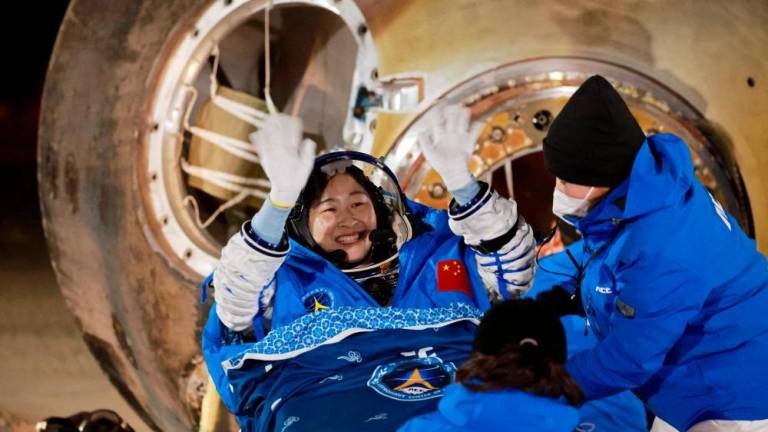 Astronaut Liu Yang waves as she is out of a return capsule of the Shenzhou-14 spacecraft, following a six-month mission on China’s space station, at the Dongfeng landing site in Inner Mongolia Autonomous Region, China December 4, 2022. REUTERSPIX