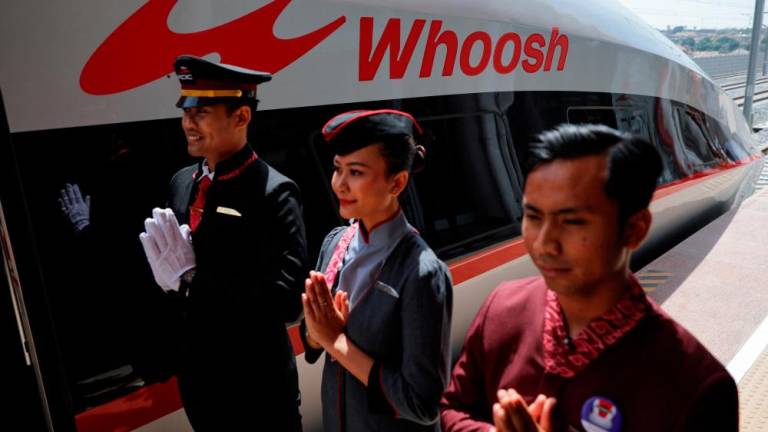 Staff stand to greet passengers of the China-backed high-speed railway connecting Jakarta and Bandung called “Whoosh”, as it parks at Padalarang station in West Java, Indonesia, October 2, 2023. REUTERSPIX