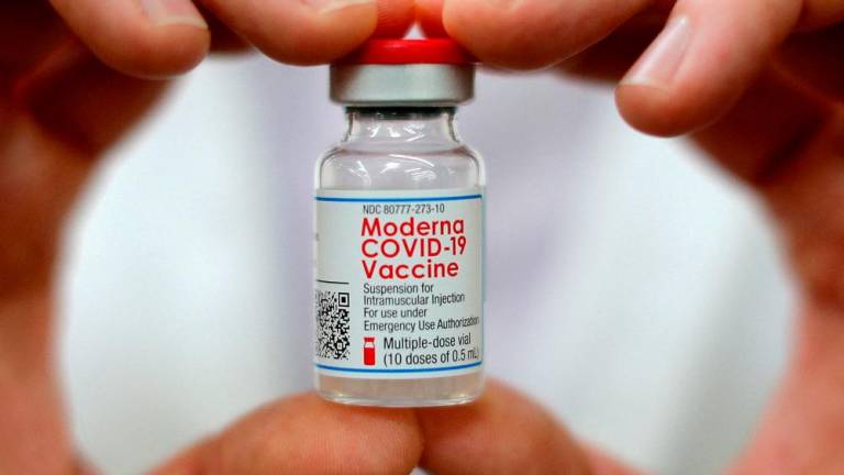 A pharmacist holds a vial of the Moderna coronavirus disease (Covid-19) vaccine in West Haven, Connecticut, U.S., February 17, 2021. REUTERSpix