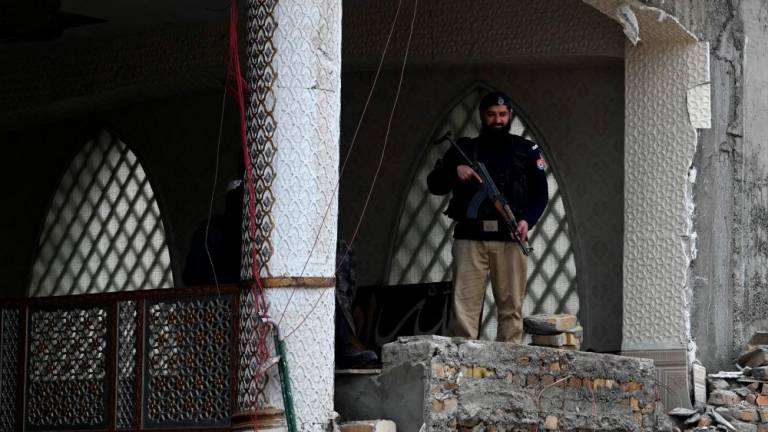 A policeman stands guard over a damaged mosque following January’s 30 suicide blast inside the police headquarters in Peshawar on February 1, 2023. AFPPIX
