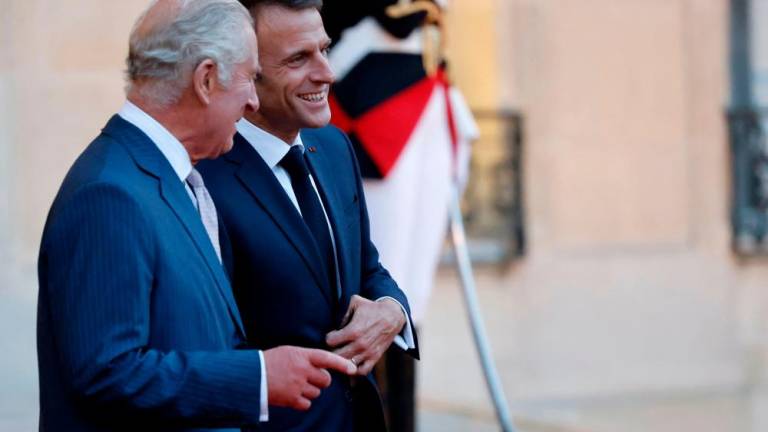 Britain's King Charles III (L) bids farewell to French President Emmanuel Macron at the Elysee Presidential Palace in Paris, on September 21, 2023, before departing for Bordeaux, where the King and Queen will continue their three day state visit to France. AFPPIX