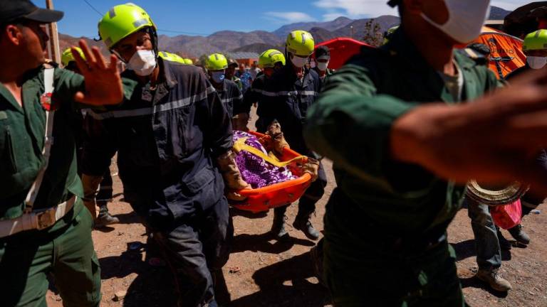 Rescue workers carry the dead body of a victim of the deadly earthquake in Talat N’yaaqoub, Morocco, September 11, 2023. REUTERSPIX