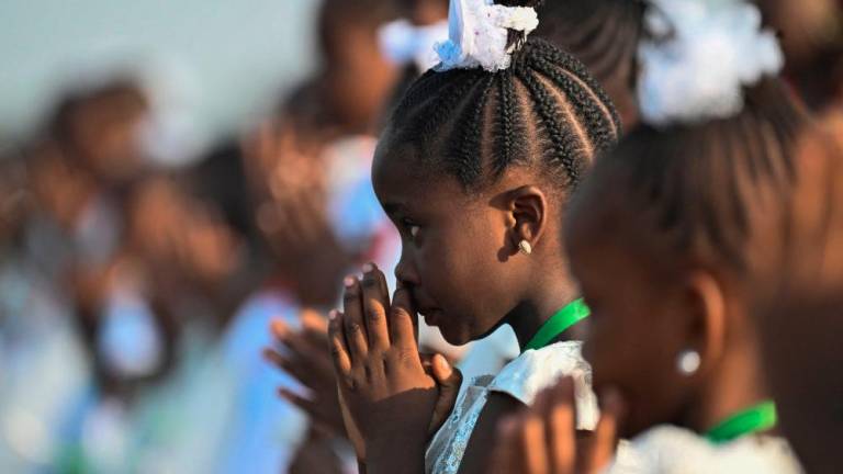 A girl looks on as attendees gather ahead of the arrival of Pope Francis for the mass at the N’Dolo Airport in Kinshasa, Democratic Republic of Congo (DRC), on February 1, 2023. AFPPIX