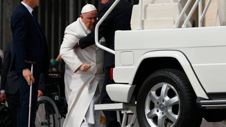 Pope Francis is helped get up the popemobile car as he leaves on March 29, 2023 at the end of the weekly general audience at St. Peter’s square in The Vatican. AFPPIX