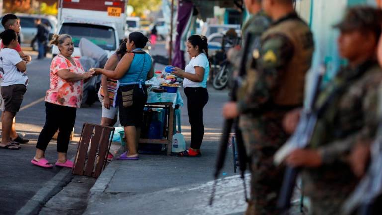 Women sell snacks on a street of Las Margaritas neighborhood during an anti-gang patrol following a year-long state of emergency against gangs, in Soyapango, El Salvador March 24, 2023. REUTERSpix