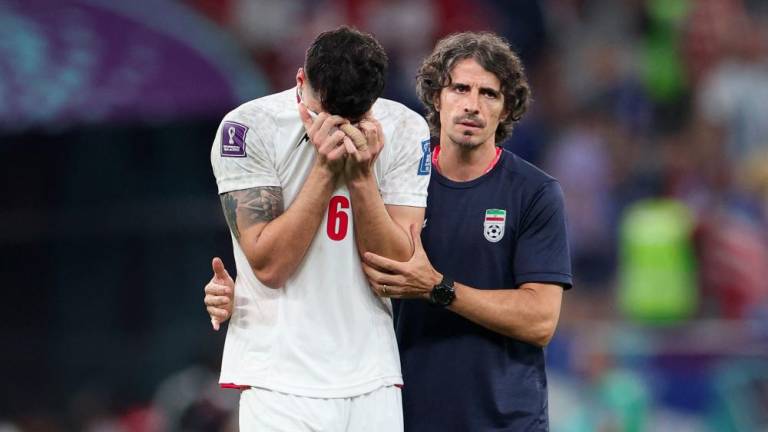 TOPSHOT - Iran's midfielder #06 Saeid Ezatolahi is comforted as he cries at the end of the Qatar 2022 World Cup Group B football match between Iran and USA at the Al-Thumama Stadium in Doha on November 29, 2022. - AFPPIX