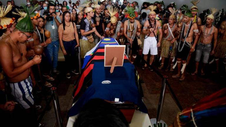 Xukuru´s indigenous people sing a sacred pray in honor of the Brazilian indigenous expert Bruno Pereira next to his coffin during his funeral at the Morada da Paz Cemetery in Paulista, Pernambuco state, Brazil, on June 24, 2022. AFPPIX