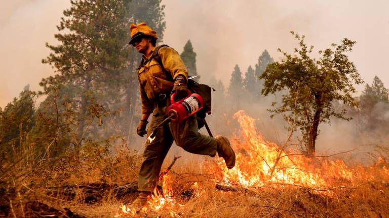 A firefighter walks while battling flames at Volcanoville, California, U.S. September 9, 2022. - REUTERSPIX