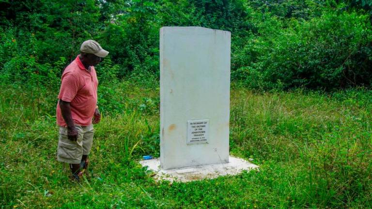 Fitz Duke looks at the memorial site for the victims of the Jonestown Massacre (1978) in Jonestown, Guyana, on September 21, 2022. Deep in the Guyanese jungle, only a signpost and a nondescript plaque serve as memories of a cult settlement where one of the most spine-chilling mass murder-suicides in modern history took place almost five decades ago. AFPPIX