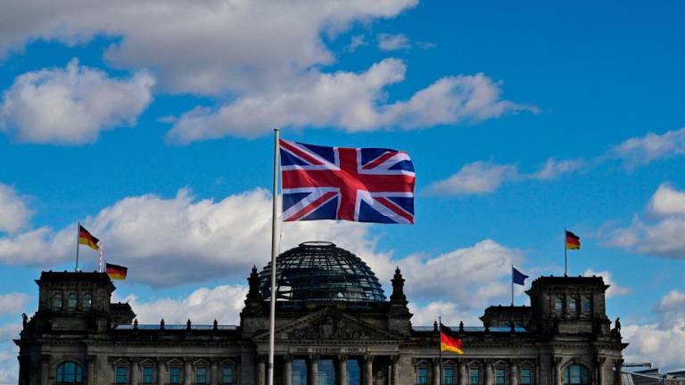 The Union Jack flies in front of the Reichstag building that houses the Bundestag (lower house of parliament) in Berlin on March 28, 2023, ahead of the visit of Britain’s King Charles III to the German capital/AFPPix