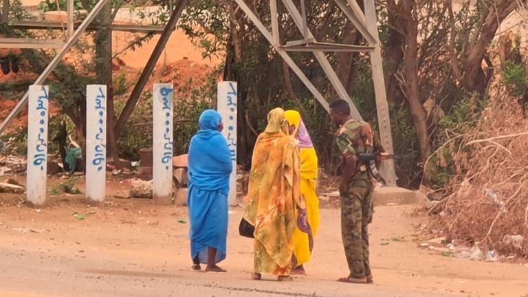 An army soldier talks to women on a street in Khartoum on June 6, 2023, as fighting continues in war-torn Sudan. AFPPIX