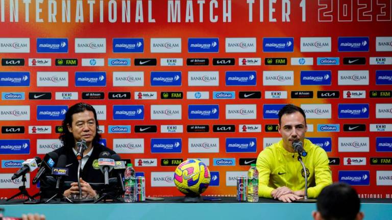 JOHOR BAHRU, March 22 -- Malaya Tigers coach Kim Pan Gon (left) with team captain Dion Cools at a press conference ahead of the Tier 1 International friendly against Turkmenistan at a hotel today. BERNAMAPIX