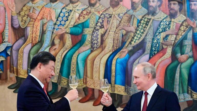 Russian President Vladimir Putin and China's President Xi Jinping make a toast during a reception following their talks at the Kremlin in Moscow on March 21, 2023. AFPPIX