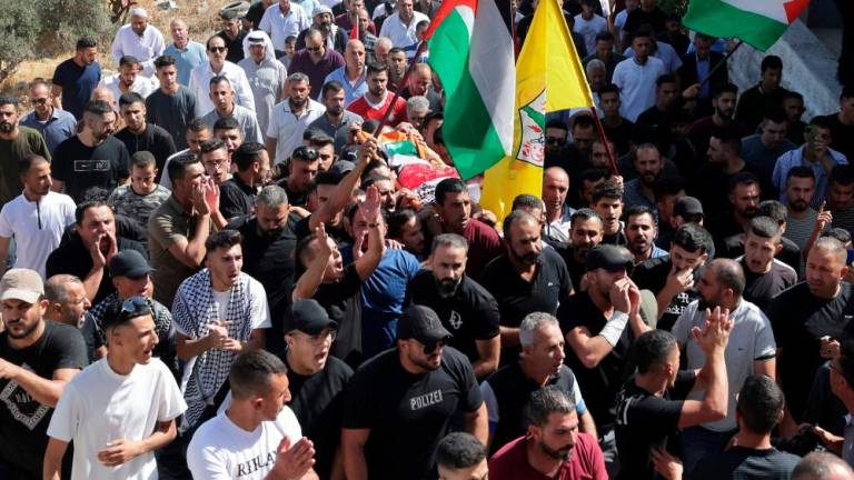 Palestinian mourners carry the body of seven-year-old Palestinian, Rayan Suleiman, who died the day before in unclear circumstances in the village of Tuqu, during his funeral in the village, south of Bethlehem in the occupied West Bank, on September 30, 2022. AFPPIX