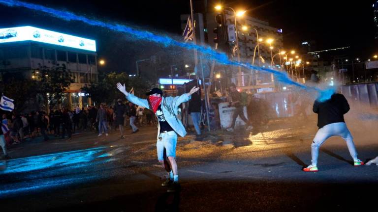 Israeli security forces use water canons to disperse protesters during ongoing demonstrations in Tel Aviv on March 27, 2023. AFPPIX