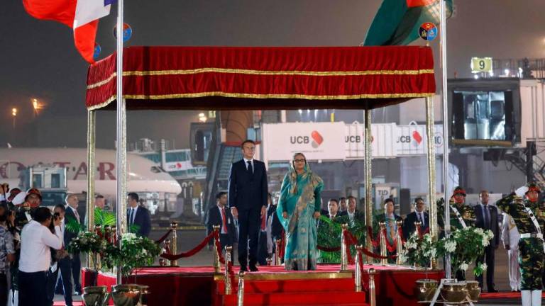French President Emmanuel Macron and Bangladesh’s Prime Minister Sheikh Hasina take part in an official welcome ceremony at the international airport in Dhaka upon Macron’s arrival for a two-day-official visit on September 10, 2023. AFPPIX