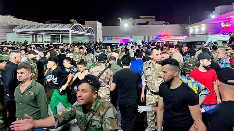 Soldiers and emergency responders among others gather around ambulances carrying wounded people after a fire broke out at a wedding hall during a celebrations, outside the Hamdaniyah general hospital in Bakhdida, Iraq on September 27, 2023. AFPPIX