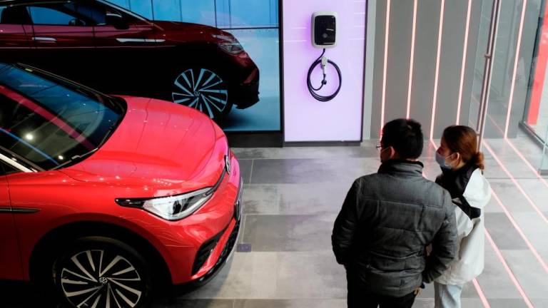 A Volkswagen ID.4 X electric vehicle is displayed inside an ID. Store X showroom in Chengdu, China. Volkswagen launched its new-generation of ID. series in China early last year. – Reuterspix