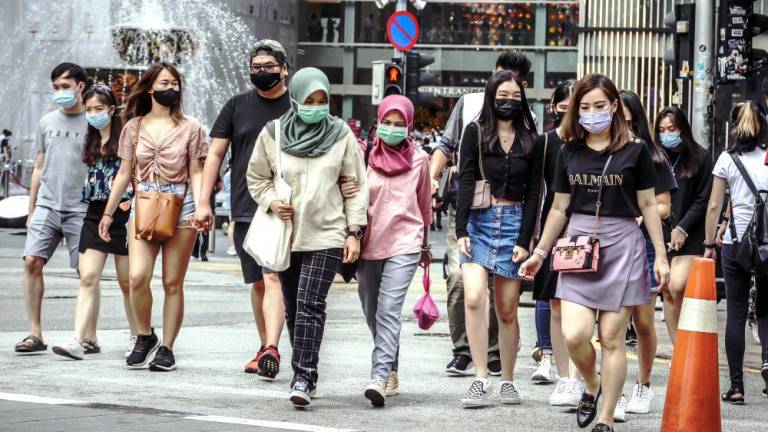 Sanjay said the idea of wearing a mask when speaking to someone who has had Covid-19 and has returned to work is not necessary, and even the World Health Organisation does not promote the wearing of face masks anymore. – ADIB RAWI YAHYA/THESUN
