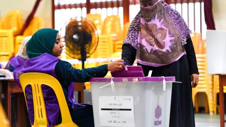 A voter casts her ballot at a polling station during the second round of Maldives' presidential election in Male on September 30, 2023. AFPPIX
