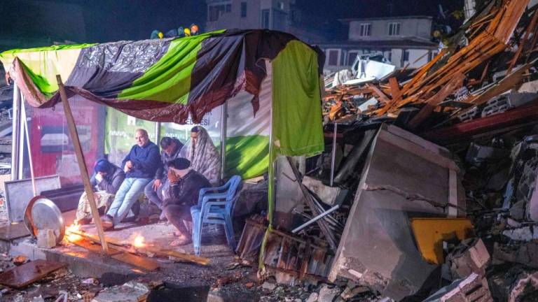 People take rest next to bonfire in the rubble in Hatay, after a 7.8-magnitude earthquake struck the country’s southeast on February 6, 2023. AFPPIX