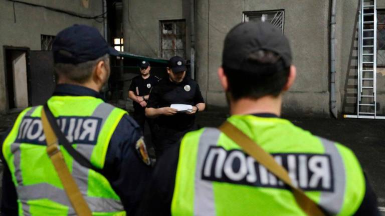 Ukrainian police officers attend a briefing prior to their night shift in the southern Ukrainian port city of Odesa, on May 25, 2023, amid the Russian invasion of Ukraine. As the war broke out, figures in high-level, international organised crime groups left Russia and Ukraine for places like Central Asia and the Gulf states. AFPPIX