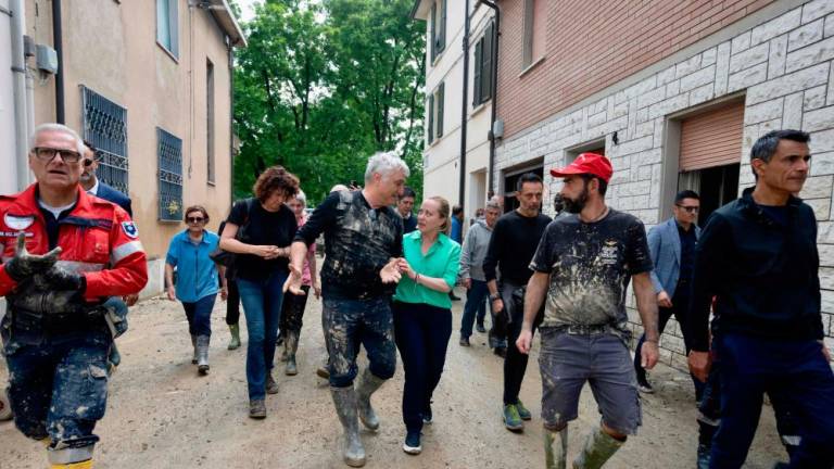 This photo taken and issued as a handout by the Palazzo Chigi press office of Italy’s prime minister on May 21, 2023 shows Italy’s Prime Minister, Giorgia Meloni (C-R) meeting with volunteers while visiting the town of Faenza after deadly floodwaters hit the Emilia-Romagna region. AFPPIX