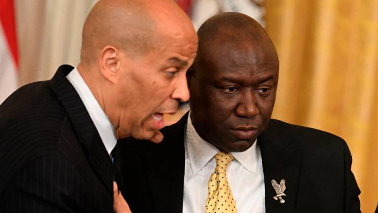 US Senator Cory Booker (D-NJ) and US attorney Ben Crump speak prior to a signing ceremony in the East Room of the White House in Washington, DC, on May 25, 2022. US President Joe Biden is expected to sign an Executive Order to advance policing and strengthen public safety. AFPPIX