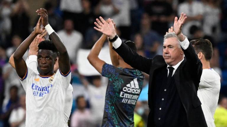 Real Madrid’s Brazilian forward Vinicius Junior (L) and Real Madrid’s Italian coach Carlo Ancelotti acknowledge the crowd at the end of the Spanish league football match between Real Madrid CF and Real Betis at the Santiago Bernabeu stadium in Madrid on May 20, 2022. AFPPIX