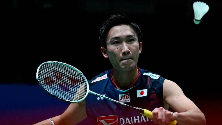 Japan’s Kento Momota hits a return against Thailand’s Kunlavut Vitidsarn during their men’s singles semi-final match at the Malaysia Open badminton tournament in Kuala Lumpur on July 2, 2022. AFPPIX