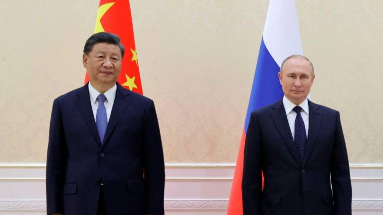 China’s President Xi Jinping and Russian President Vladimir Putin pose with Mongolia’s President during their trilateral meeting on the sidelines of the Shanghai Cooperation Organisation (SCO) leaders’ summit in Samarkand on September 15, 2022. AFPPIX