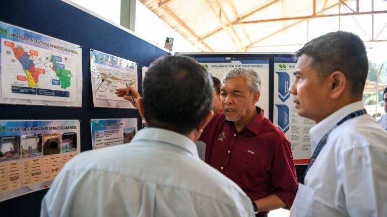 SIK, May 16 -- Deputy Prime Minister Datuk Seri Dr Ahmad Zahid Hamidi discussed something while listening to a briefing from MADA management after inspecting the water level situation at Sik’s MUDA Dam here today. BERNAMAPIX